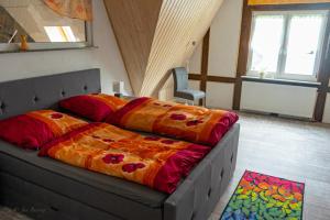 a bedroom with a bed with colorful sheets on it at Wohlfühl-Villa in Themar in Themar +12 photos
