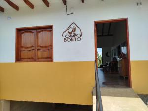 een deur naar de ingang van een gebouw met een dmg domino bord bij Campo Bonito in Jericó