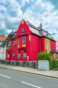 a large red building on the side of a street at Wohlfühl-Villa in Themar in Themar