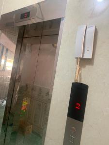 a phone on a wall next to a glass case at Hưng Hà Hotel DB - by BAY LUXURY in Diện Biên Phủ