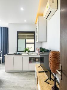 a kitchen with white cabinets and a sink at Green Line Long Bien - Serviced Apartment - Ngoc Thuy - Hanoi in Hanoi