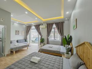 sala de estar con 2 camas y sofá en Simi Homestay en Vung Tau
