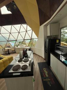 a kitchen with a stove top oven in a room at Superb Romantic DOME Villeta Hot Tub Only 4x4 or motorbike in Villeta