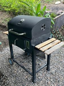 a black stove with a wooden bench next to it at Superb Romantic DOME Villeta Hot Tub Only 4x4 or motorbike in Villeta