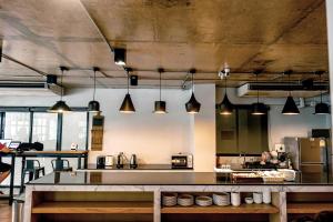 a large kitchen with a large counter in it at Travelier Hostel in Bangkok