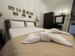 ein Schlafzimmer mit 2 Betten und weißen Handtüchern darauf in der Unterkunft Alice Maisonette & Studios in Adamas