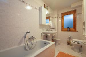 ein Badezimmer mit Badewanne, Toilette und Waschbecken in der Unterkunft Appartement Beauregard 1 - Happy Rentals in Les Houches