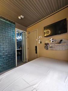 Postel nebo postele na pokoji v ubytování 榆迪賓館 YUTIK Guesthouse
