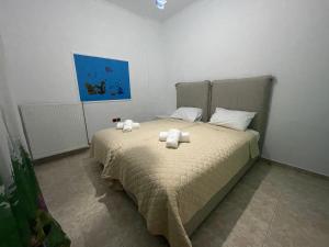 a bedroom with a bed with two towels on it at Alice Maisonette & Studios in Adamantas