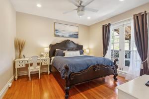 a bedroom with a bed and a desk and a window at Beautiful Spacious Victorian Garden Oasis Central, Gated, Deck, BBQ in San Rafael