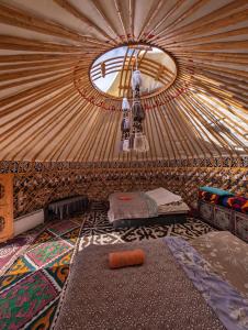 a interior of a yurt with a window and a bed at Barskoon Guest House in Barskoon
