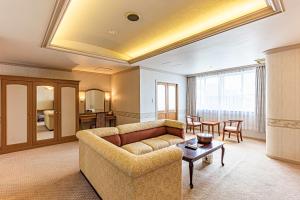 sala de estar con sofá y mesa en Okinawa Hotel en Naha