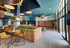 a restaurant with a bar with chairs and tables at Waterfall Paradise Entire Executive 1 Bed Apt in Midrand