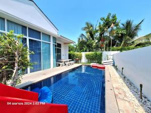 a swimming pool in the backyard of a house at บีชทาวน์ ชะอำ พูลวิลล่า ห่างหาดชะอำ2กม Beach town cha-am poolvilla from Cha-Am beach just 2km in Cha Am