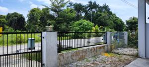 una valla de hierro con una puerta en un patio en Farwis Homestay, en Mukah