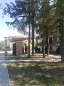 a building with trees in front of it at Apartament przy tężni in Augustów