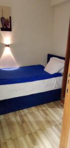 a bed in a room with a blue and white mattress at Hotel Group in Cairo