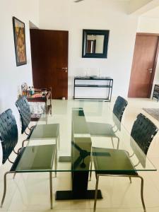 a living room with a glass table and chairs at 3 Bedroom Apartment - Iconic Residences Colombo in Sri Jayewardenepura Kotte