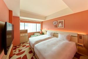 Postel nebo postele na pokoji v ubytování The Royal Park Hotel Ginza 6-Chome + 37 fotografií