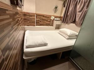 Voodi või voodid majutusasutuse 3D Inn Hong Kong Romance toas