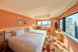 a hotel room with a bed and a large window at The Royal Park Hotel Ginza 6-Chome in Tokyo