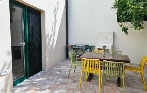 a wooden table and chairs on a patio at Apartment MoiRai in Gračišče