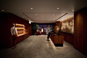 a lobby with two people standing in a room at Hotel Grand Bach Kyoto Select in Kyoto