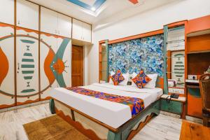 a bedroom with a bed in a room at FabHotel Rest & Peace in Ahmedabad