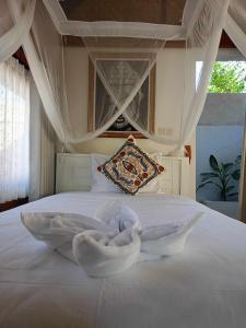 Bintang Tiga Bungalows Gili Air客房内的一张或多张床位