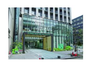 un grand bâtiment en verre avec une entrée. dans l'établissement Prince Smart Inn Osaka Yodoyabashi, à Osaka