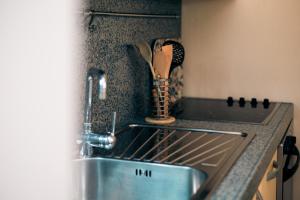 a kitchen counter with a sink in a kitchen at Marina View Syvota in Sivota +56 photos