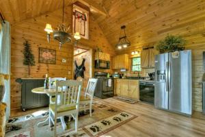 a kitchen with a table and a refrigerator at Stargazer in Ellijay +31 photos