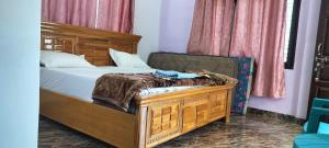 a bedroom with a bed with a wooden frame at Limewood homestay in Almora
