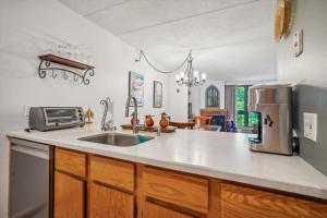 a kitchen with a sink and a microwave at Pinnacle E17 in Killington