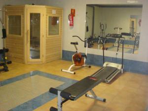 a gym with several exercise equipment in a room at Apartamentos Azahar in Puente de Génave