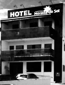 a hotel with a sign on top of a building at Hotel Morada do Sol in Araxá