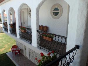 a balcony of a house with flowers on it at Mercan Köşk in Alaçatı