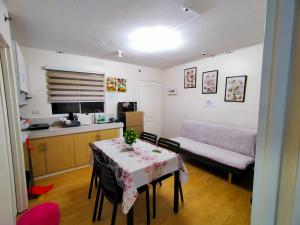 a living room with a table and a kitchen at Two-Bedroom at San Remo Oasis in Cebu City