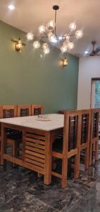 a dining room with a table and some chairs at Bella Casa in Vagamon