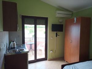 a kitchen with a door leading to a patio at Cheap Montenegro Apartments in Dobra Voda