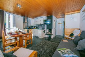 a kitchen and living room with a couch and a table at Residence de Lognan- Les Jorasses 26 - Happy Rentals in Chamonix-Mont-Blanc