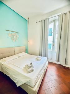 a bedroom with a white bed with a blue wall at La Siesta in La Maddalena