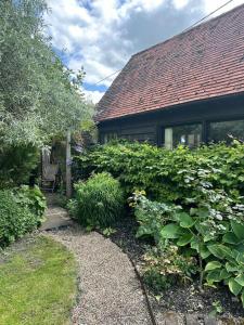 a house with a garden with a bench and bushes at Garden Cottage in Henley on Thames +15 photos