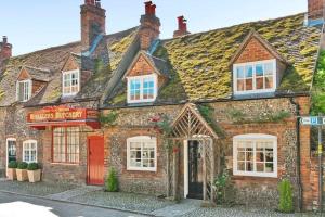 an old brick building with a red door at Garden Cottage in Henley on Thames