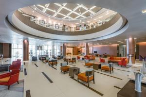 a lobby of a hospital with chairs and tables at Four Points by Sheraton Al Ain in Al Ain