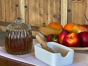 Nuwefonteinskop Lodge في Kotzesrus: طاولة مع وعاء من الفواكه وصحن من التفاح