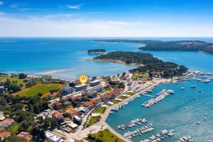 an aerial view of a harbor with boats in the water at Fly Apartments Medulin - 50m from the Beach - NEW 2024 in Medulin