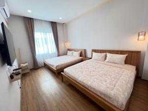 Postel nebo postele na pokoji v ubytování M2H Poolvilla Cha-am