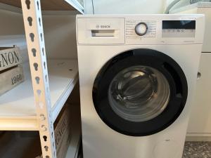 a washer and dryer in a laundry room at Stylish Townhouse in Havelock North