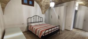 a bedroom with a bed in a white room at Appartamento di Porta Maggiore in Cupra Marittima